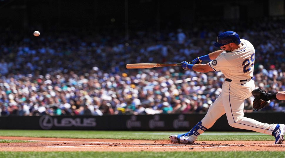 Seattle Mariners designated hitter Cal Raleigh hits a two-run home run against the Tampa Bay Rays during the first inning of a baseball game Sunday, Aug. 10, 2025, in Seattle. (AP Photo/Lindsey Wasson)