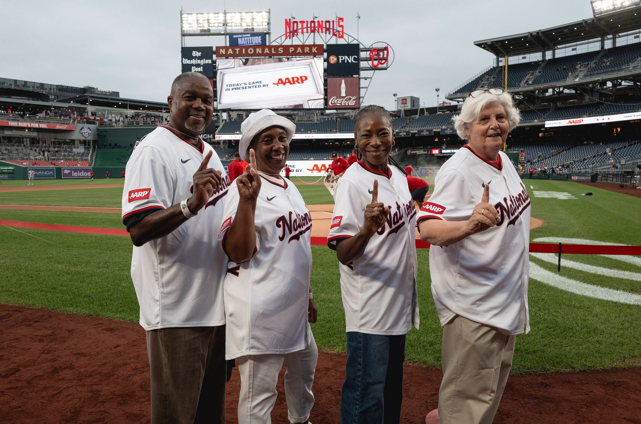 people posing for a group photo in baseball jerseys