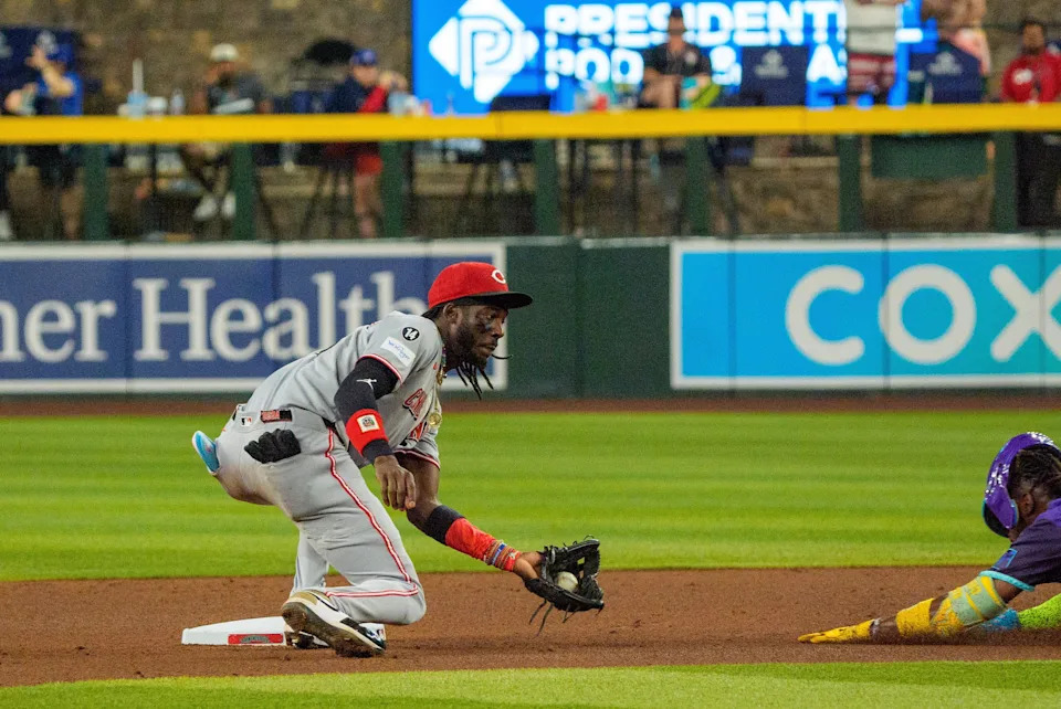 Shortstop Elly De La Cruz prepares to tag out the Diamondbacks' Geraldo Perdomo at second base on a steal attempt in the fourth inning Aug. 22. Catcher Jose Trevino made the throw.
