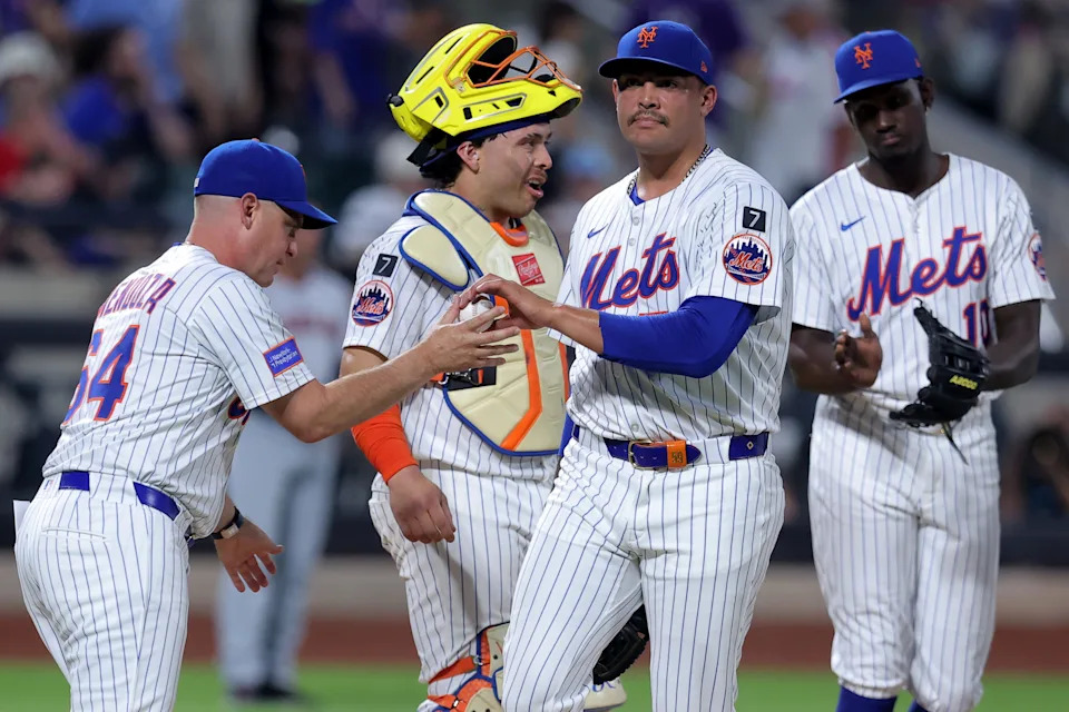 Aug 4, 2025; New York City, New York, USA; New York Mets manager Carlos Mendoza (64) takes the ball from starting pitcher Sean Manaea (59) during a pitching change during the sixth inning against the Cleveland Guardians at Citi Field. Mandatory Credit: Brad Penner-Imagn Images