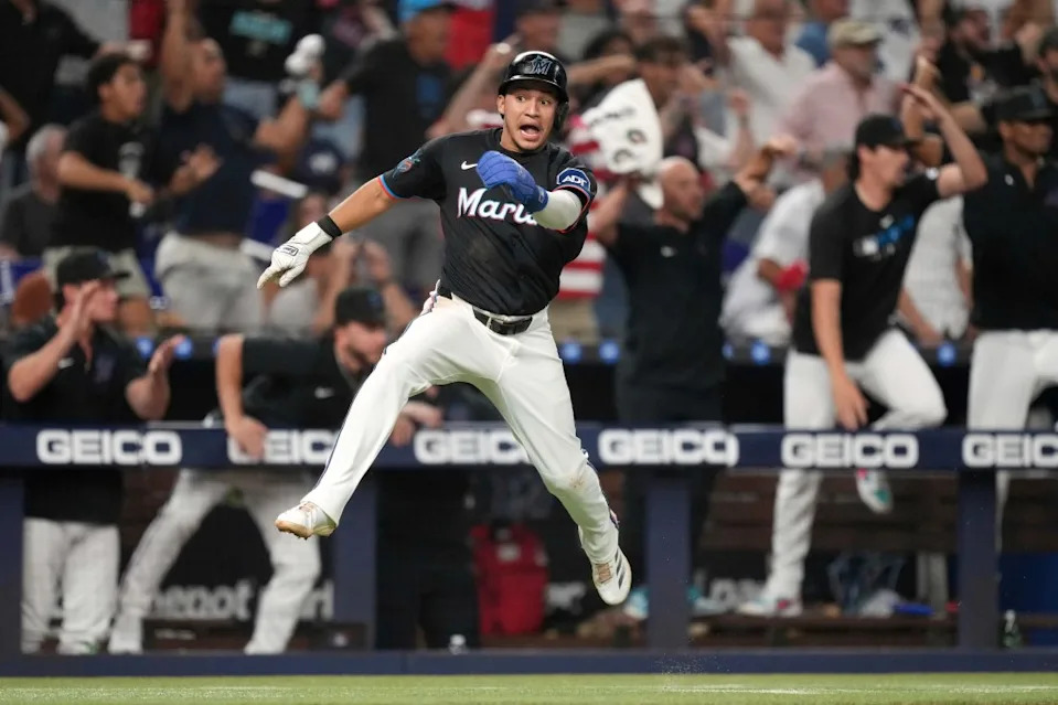 Javier Sanoja celebrates as he scores the tying run Friday. AP