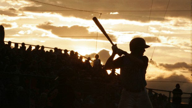 FILE - In this June 21, 2006, file photo, Beatrice Bruins' Travis Tucker takes his turn at bat during the fifth inning of the Midnight Sun game between the Bruins and the Alaska Goldpanners in Fairbanks, Alaska. The Alaska Baseball League has canceled its summer season, as the future of sports worldwide remains uncertain during the coronavirus pandemic. The league website says this season will be canceled to keep everyone safe from exposure to COVID-19. (AP Photo/Nora Gruner, File)