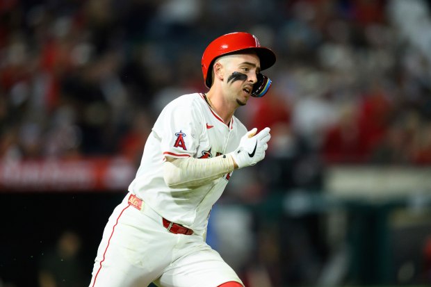 The Angels’ Zach Neto runs after hitting an RBI double...