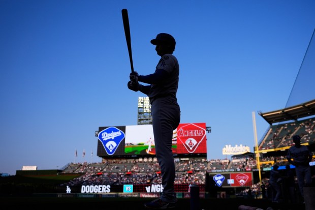 Dodgers star Shohei Ohtani stands in the on-deck circle during the first inning of a baseball game against the Los Angeles Angels, Wednesday, Aug. 13, 2025, in Anaheim, Calif. (AP Photo/Mark J. Terrill)