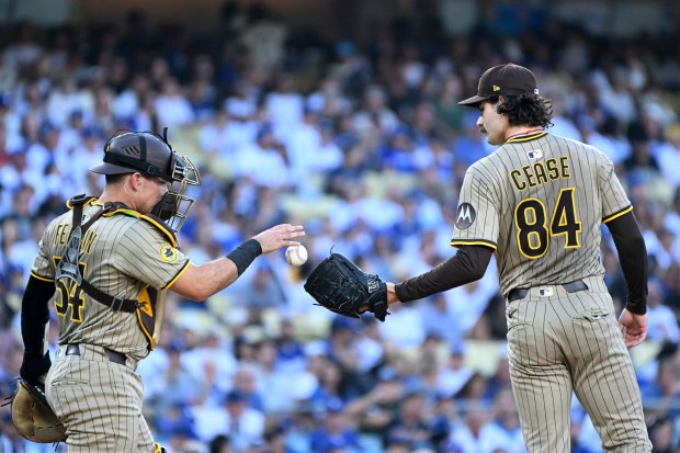 San Diego Padres starting pitcher Dylan Cease, right, meets at...