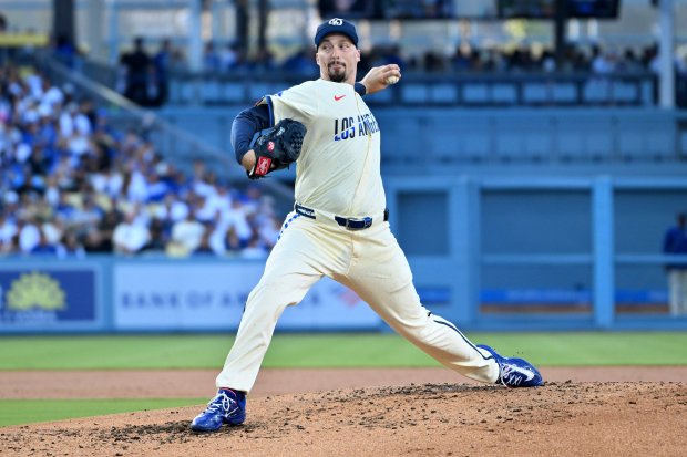 Dodgers starting pitcher Blake Snell throws to the plate during...