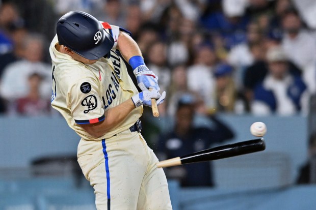 The Dodgers’ Will Smith breaks his bat as he grounds...