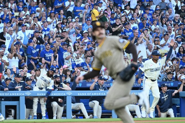 Fans cheer as the Dodgers score two runs against the...