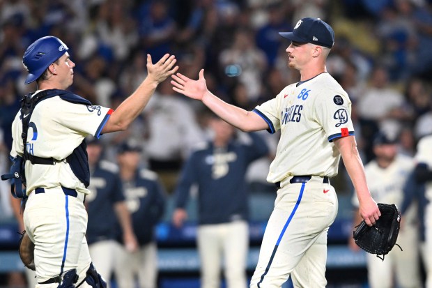 Dodgers catcher Will Smith, left, and relief pitcher Jack Dreyer...