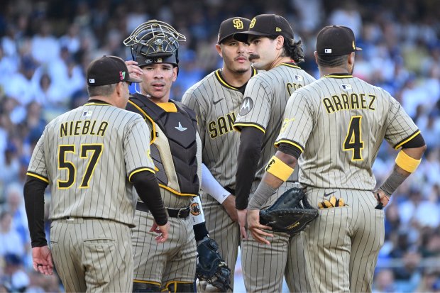 San Diego Padres pitching coach Ruben Niebla (57) walks out...