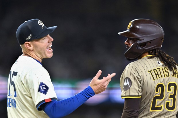 Dodgers first baseman Freddie Freeman, left, and San Diego Padres...