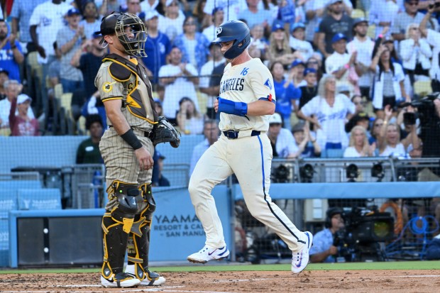 The Dodgers’ Will Smith scores a run in front of...