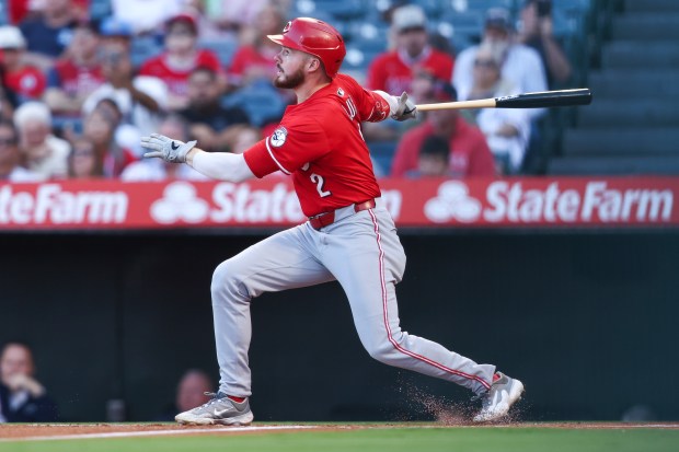 Cincinnati Reds designated hitter Gavin Lux follows through on a...