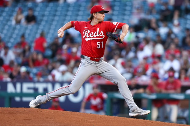 Cincinnati Reds pitcher Brady Singer throws to the plate during...