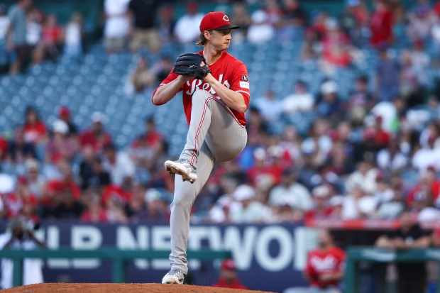 Cincinnati Reds pitcher Brady Singer throws to the plate during...