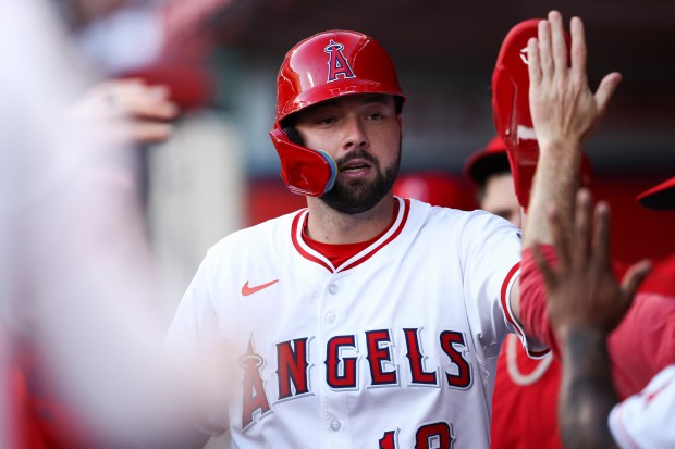 The Angels’ Nolan Schanuel celebrates in the dugout after scoring...