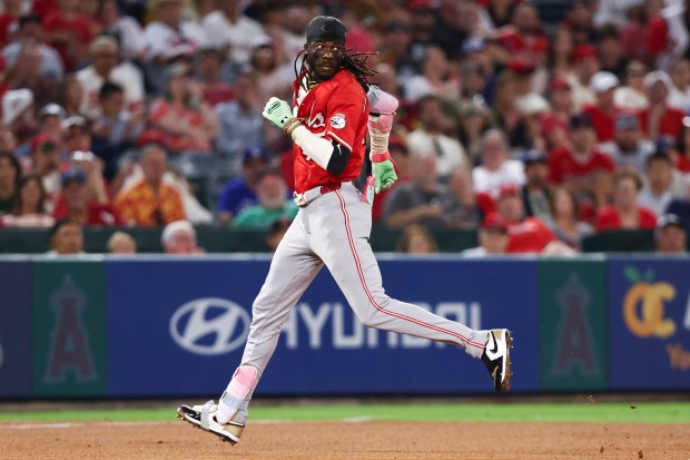 The Cincinnati Reds’ Elly De La Cruz looks back while...
