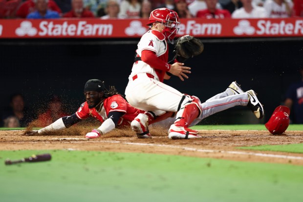 The Cincinnati Reds’ Elly De La Cruz slides into home...