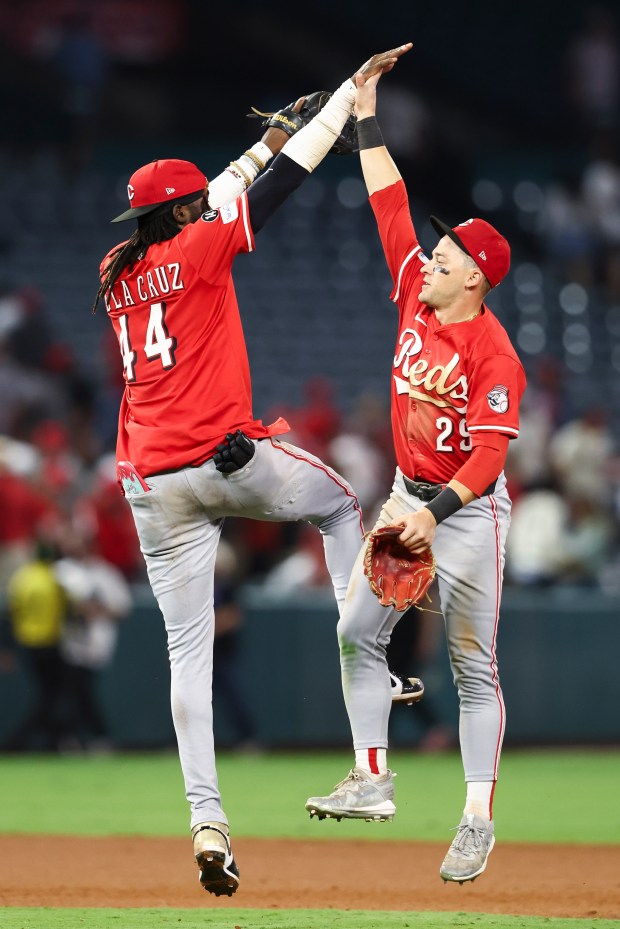 Cincinnati Reds shortstop Elly De La Cruz, left, and center...