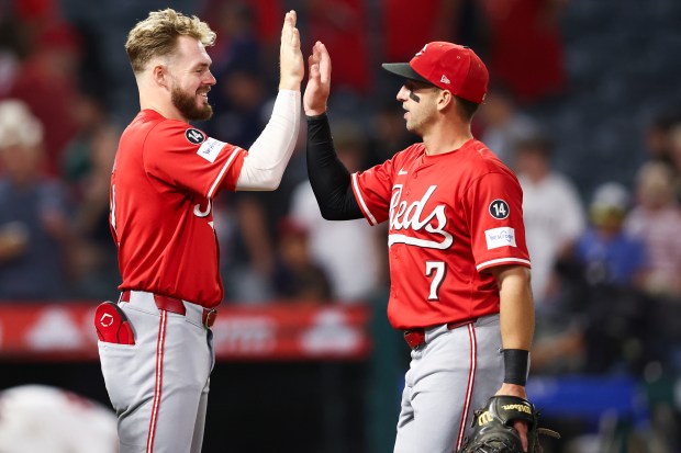 The Cincinnati Reds’ Gavin Lux, left, and first baseman Spencer...