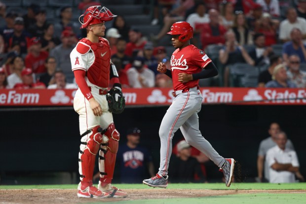Cincinnati Reds’ Ke’Bryan Hayes runs towards home plate to score...