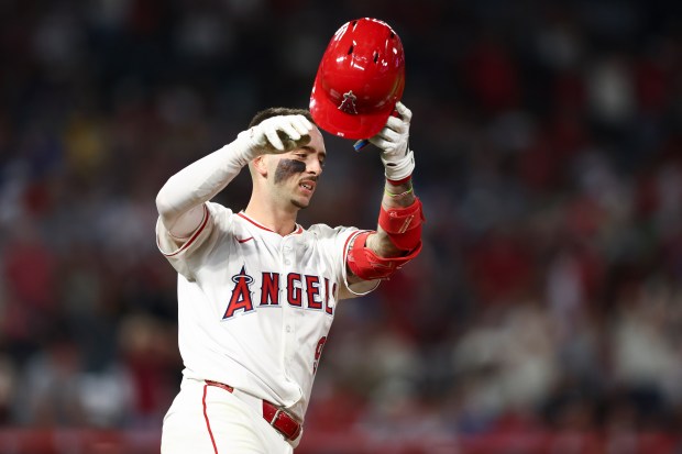 The Angels’ Zach Neto reacts after flying out during the...