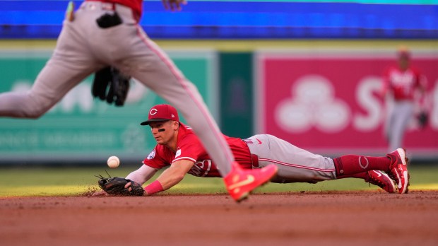 Cincinnati Reds second baseman Matt McLain, right, dives for a...