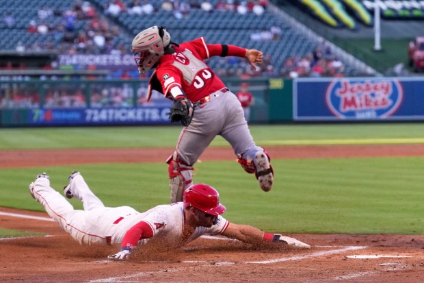 Angels star Mike Trout, below, scores on single by Taylor...