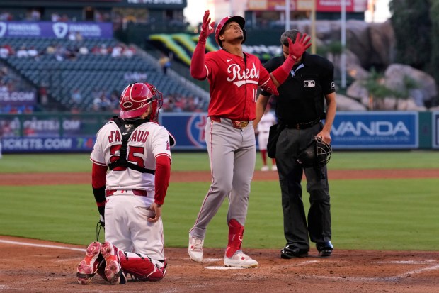 The Cincinnati Reds’ Noelvi Marte, center, gestures as he scores...