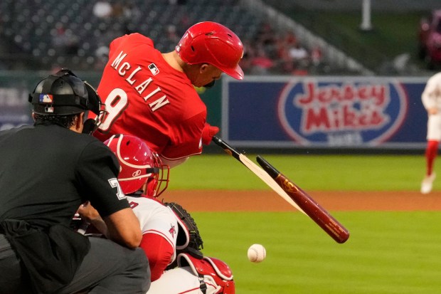 The Cincinnati Reds’ Matt McLain, right, breaks his bat before...