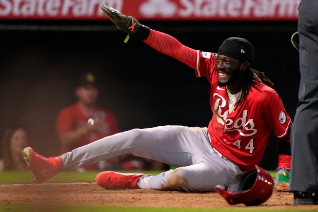 The Cincinnati Reds’ Elly De La Cruz smiles after scoring...