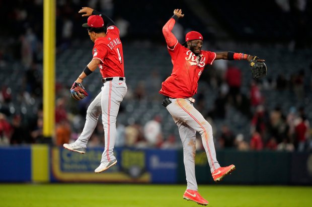 The Cincinnati Reds’ Santiago Espinal, left, and Elly De La...