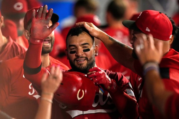 The Cincinnati Reds’ Jose Trevino is congratulated by teammates in...