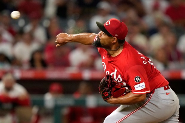 Cincinnati Reds relief pitcher Tony Santillan throws to the plate...