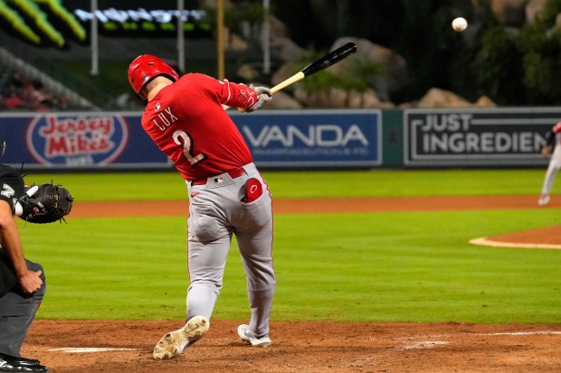 The Cincinnati Reds’ Gavin Lux hits an RBI double during...
