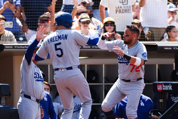 Los Angeles Dodgers’ Freddie Freeman (5) celebrates with Miguel Rojas...