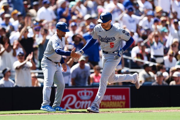 Los Angeles Dodgers’ Freddie Freeman, right, is congratulated by third...