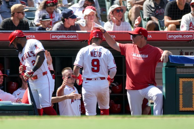 The Angels’ Zach Neto (9) is congratulated after scoring during...