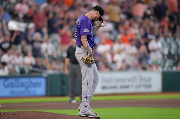Colorado Rockies starting pitcher Kyle Freeland adjusts his cap after giving up a home run to Houston Astros' Christian Walker during the first inning of a baseball game Thursday, Aug. 28, 2025, in Houston. (AP Photo/David J. Phillip)