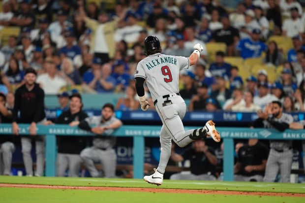 The Arizona Diamondbacks’ Blaze Alexander gestures toward his dugout as...