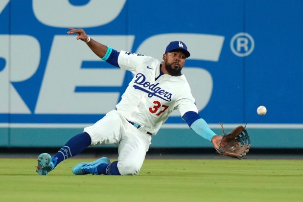 Dodgers right fielder Teoscar Hernández makes a sliding catch on...