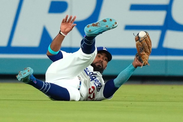 Dodgers right fielder Teoscar Hernández makes a sliding catch on...