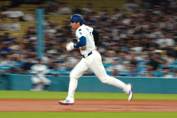 Dodgers star Shohei Ohtani runs to second as teammate Mookie...