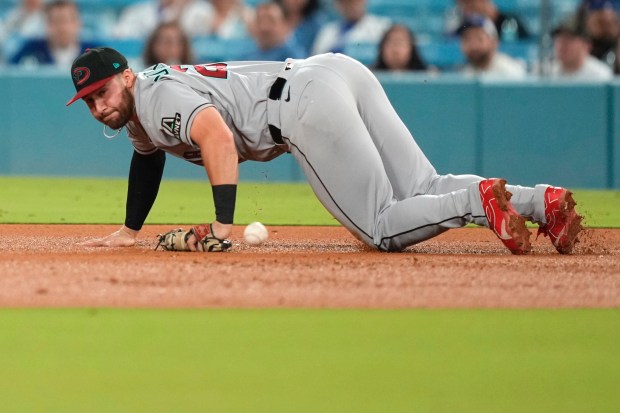 Arizona Diamondbacks first baseman Tyler Locklear stops a ball that...