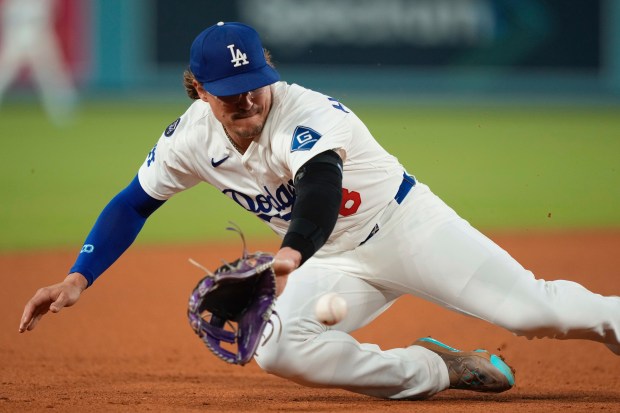 Dodgers third baseman Kiké Hernández makes a stop on a...