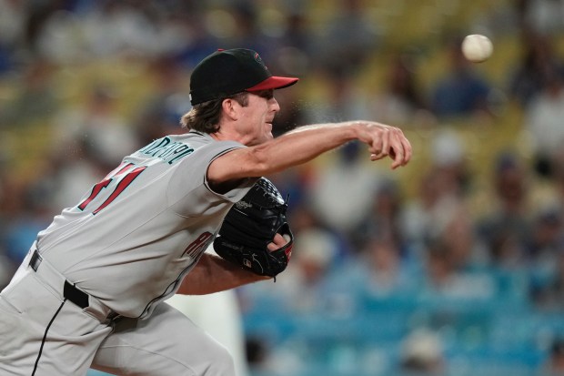 Arizona Diamondbacks relief pitcher Jake Woodford throws to the plate...