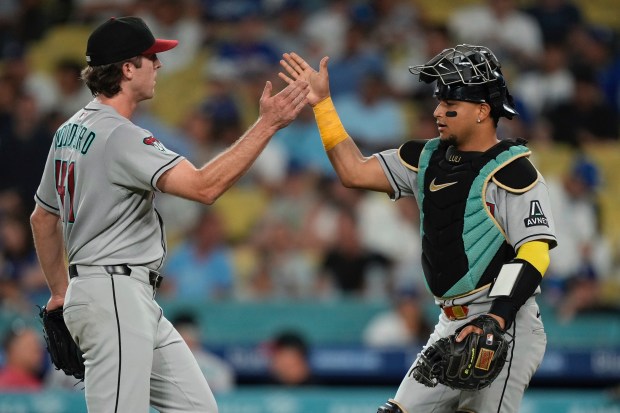 Arizona Diamondbacks relief pitcher Jake Woodford, left, and catcher James...