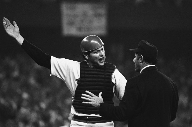 Boston catcher Carlton Fisk, left, argues with first base umpire Dick Stello that he was interfered with when Cincinnati batter Dick Stello that he was interfered with when Cincinnati batter Ed Armbrister brushed him at home plate as he threw to second trying to force out runner Cesar Geronimo, who eventually scored the winning run in the tenth inning of the third game of the World Series, Tuesday, Oct. 14, 1975, Cincinnati, Oh. Cincinnati won the game 6-5. (AP Photo/Bob Daugherty)