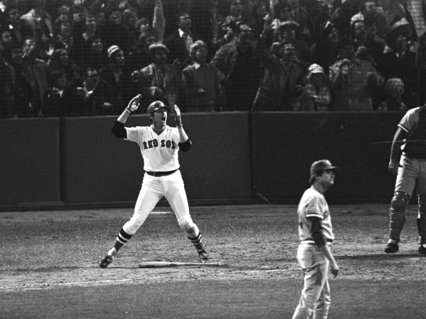 FOR USE AS DESIRED FOR THE 100TH ANNIVERSARY OF FENWAY PARK - FILE - In this Oct. 22, 1975, file photo, Boston Red Sox's Carlton Fisk, left, watches his 12th-inning home run against the Cincinnati Reds to win the sixth game of the World Series at Fenway Park in Boston. The Red Sox will celebrate the 100th anniversary of Fenway's opening on April 20, 1912, when they host the New York Yankees.    (AP Photo/Harry Cabluck, File)