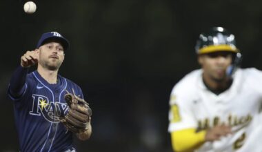 Tampa Bay second baseman Brandon Lowe, left, throws to third as Athletics' Darell Hernaiz, right, is called out during a rundown in the eighth inning of the A's 6-0 win Tuesday night in Sacramento, Calif. (AP Photo/Scott Marshall)
